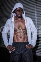 Young Bodybuilder in a hoodie looking worriedly to the ground