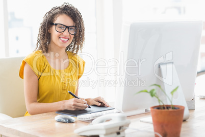 Creative young businesswoman looking at the camera