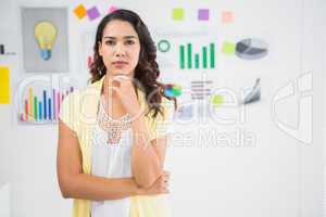 Young concentrated businesswoman looking at the camera in the of