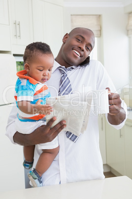 Happy smiling father with his babyboy phoning