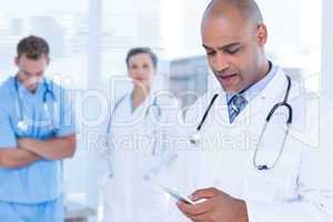 Attentive doctor sending a text message