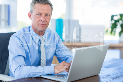 Thoughtful businessman using laptop computer