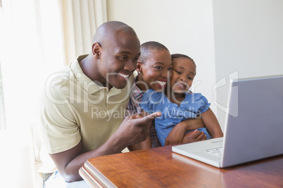 Happy smiling family using laptop