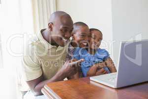 Happy smiling family using laptop