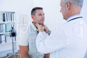 Doctor examining his patient neck