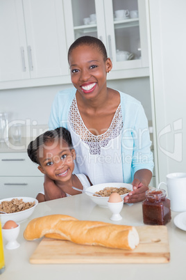 Portrait smiling mother and daughter eating together