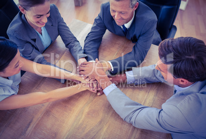 Business people joining hands in a circle