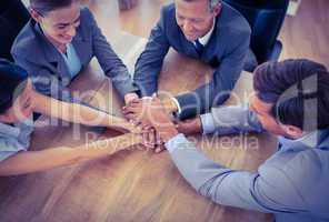 Business people joining hands in a circle