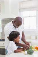 Little boy cooking with his father