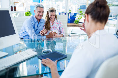 Pregnant woman and her husband discussing with doctor