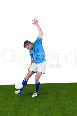 Rugby player kicking a rugby ball