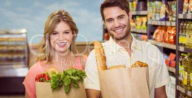 Portrait of smiling bright couple buying food products