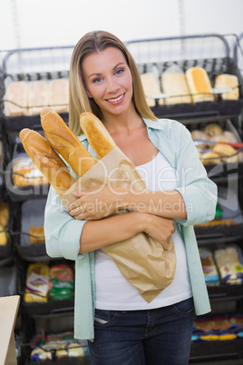 A woman buying bread in the pastries shelf