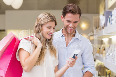 Portrait of a happy couple looking at beauty product