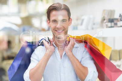 Portrait of a smiling man with shopping bags