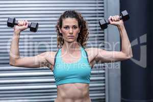 A muscular woman lifting weights