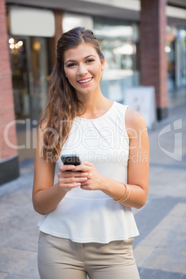 Portrait of smiling woman using smartphone