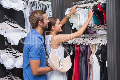 Young happy smiling couple looking at clothes