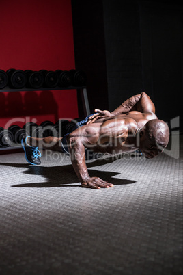 Young Bodybuilder doing One-armed push ups