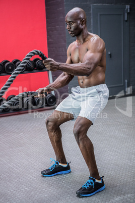 Young Bodybuilder working with ropes