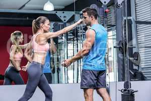 Young Bodybuilder training a young woman