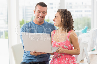 creative business colleagues holding a laptop