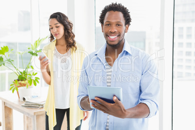 Young business people using a digital tablet and mobile phone