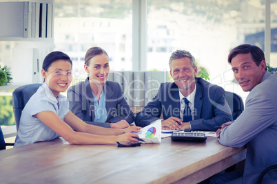 Business people looking at camera during meeting