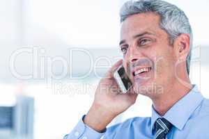 Happy businessman having a phone call