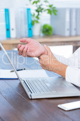 Close up view of man massaging his wrist