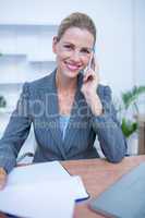 Portrait of a pretty blonde businesswoman phoning