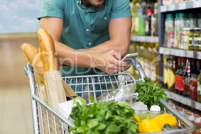 Man buy products and using his smartphone