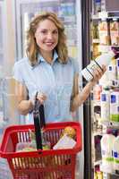 Portrait of smiling woman having on her hands a fresh milk bottl