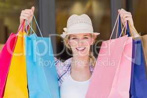 Energetic woman handing shopping bags