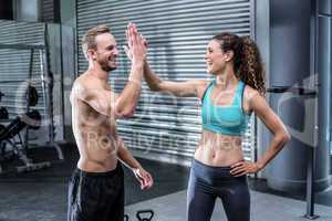 A muscular couple clapping hands