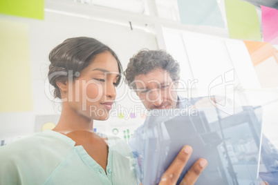 Puzzled business team looking post its on the wall