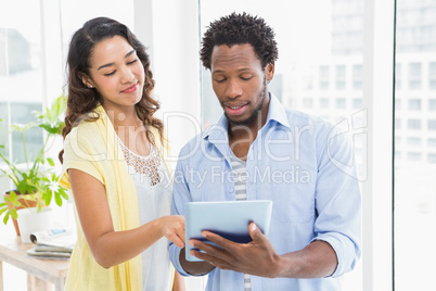 Young business people holding and using a digital tablet