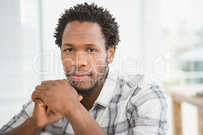 Portrait of concentrated casual businessman looking at camera