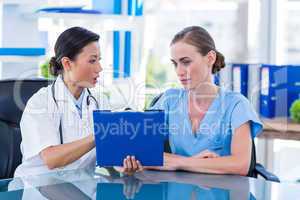 Doctor and nurse looking at clipboard