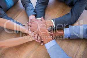 Business people joining hands in a circle