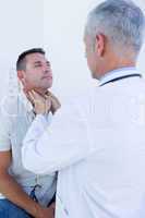 Doctor examining his patient neck