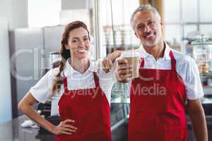 Two baristas smiling at the camera