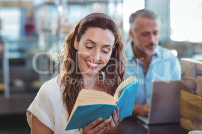 Pretty brunette reading a book