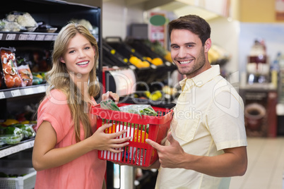 Portrait of smiling bright couple buying food products