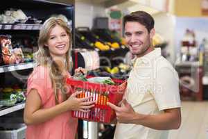 Portrait of smiling bright couple buying food products