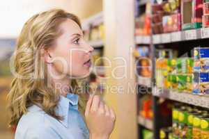 Pretty blonde woman looking at shelves