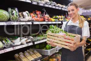 Pretty blonde carrying boxes of fresh vegetables