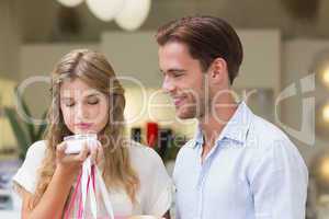 A couple testing a sample of beauty products