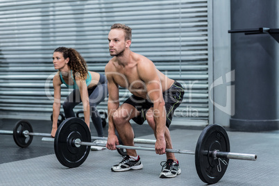 Muscular couple lifting weight together