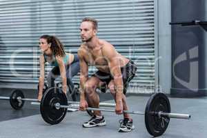 Muscular couple lifting weight together